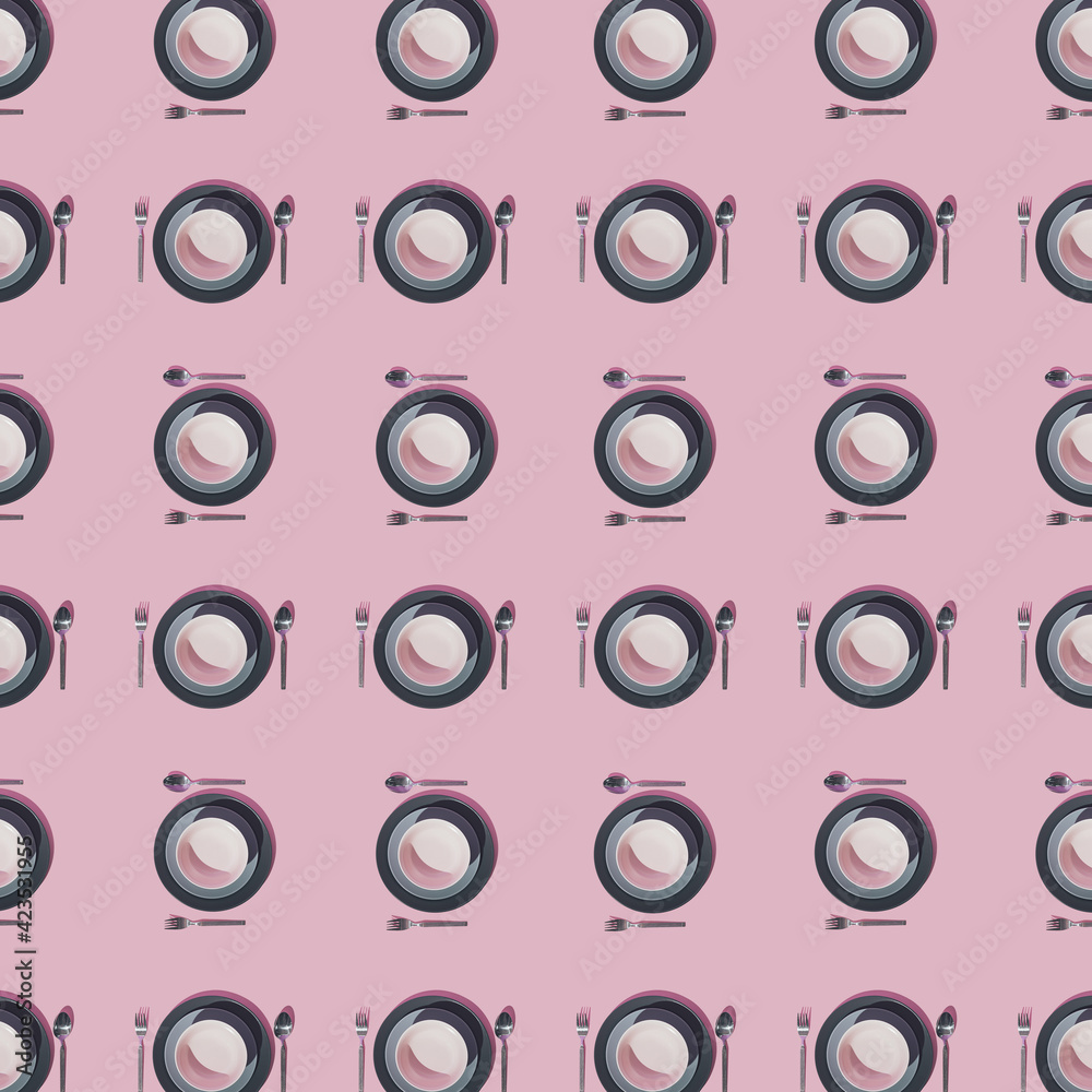 Pattern made of plates, forks and spoons on pastel pink background. Minimal layout.