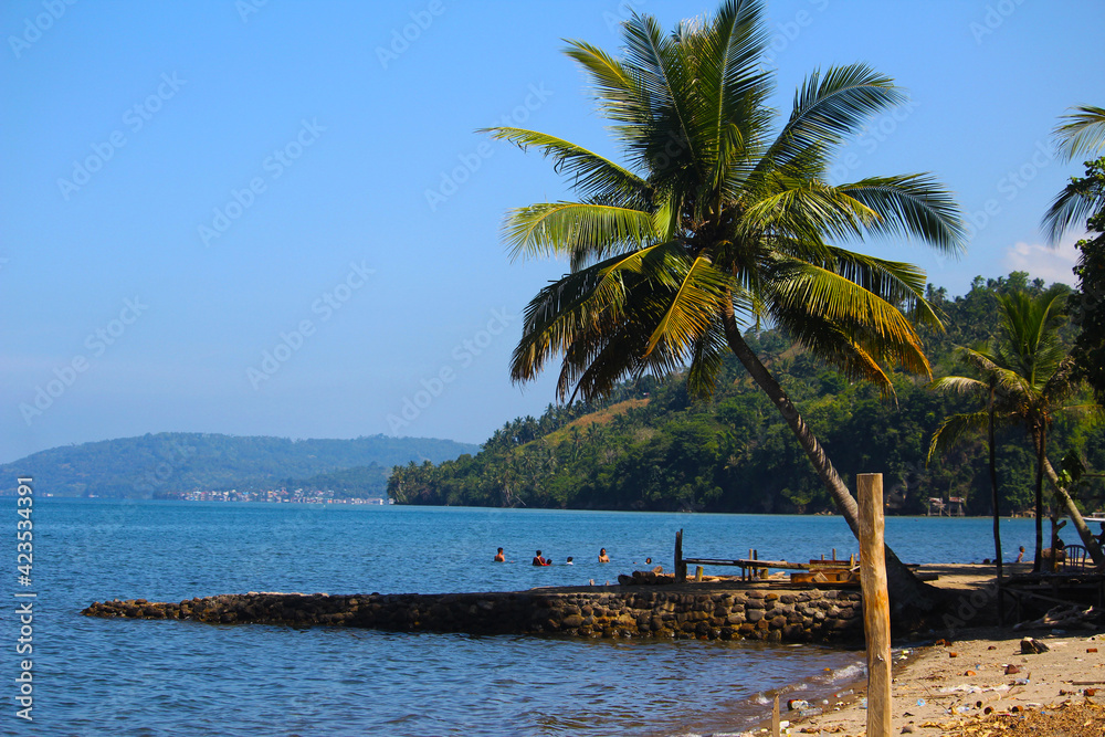 people bathing along the beach and towering coconuts on the coast of Sinjai Regency, South Sulawesi INDONESIA, 15 March 2020