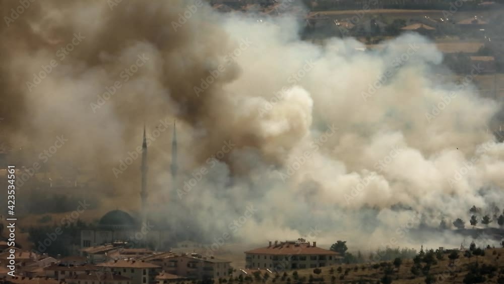 Smoke rises from the area after the terrorist attack. Bomb explodes next to mosques in Muslim country.Terror terrorism attack assault offensive missile rocket fire smoky war fighting wartime warfare