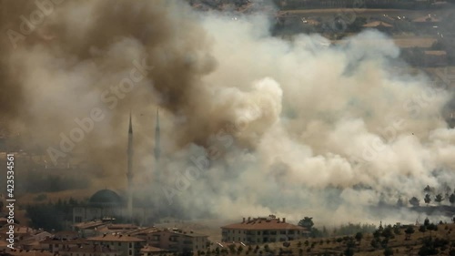 Smoke rises from the area after the terrorist attack. Bomb explodes next to mosques in Muslim country.Terror terrorism attack assault offensive missile rocket fire smoky war fighting wartime warfare photo