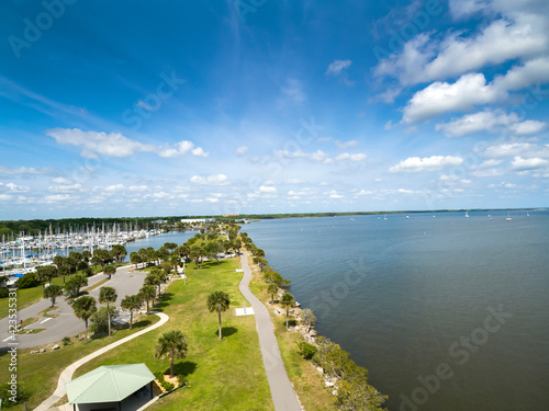 Indian River near the City of Titusville Florida on a beautiful morning with palm trees and clouds photo