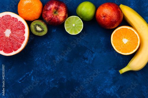Ingredients for the healthy foods selection.Mix of different fruits grapefruit  kiwi  tangerine  apple  lime  sicilian orange  orange and banana
