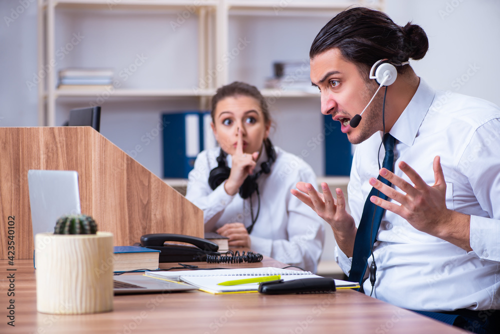 Call center operators working in the office Call center operators working in the office