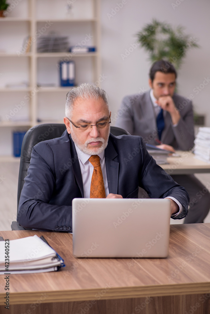 Two employees sitting at workplace
