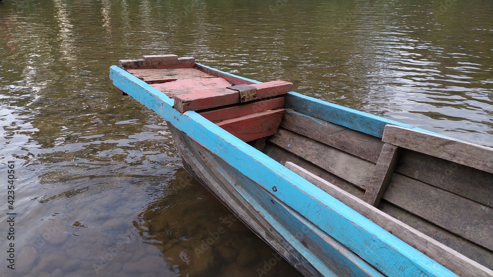 Old wooden fishing boat in river