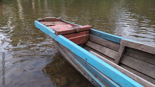 Old wooden fishing boat in river