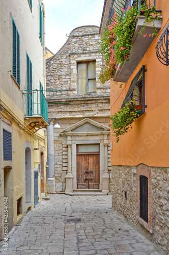 A narrow street among the old houses of Venosa  a medieval village in the Basilicata region  Italy.