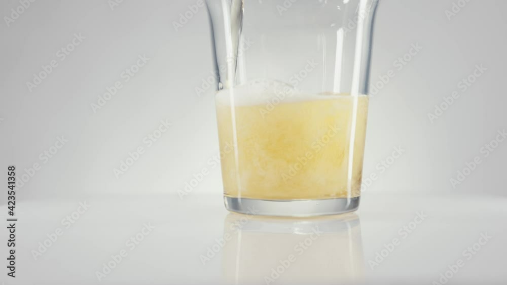 Foaming beer is poured into a glass. A pint of beer with foam in slow motion. High quality 4k footage 100fps Foaming beer is poured into a glass. A pint of beer with foam in slow motion. High quality 4k footage 100fps