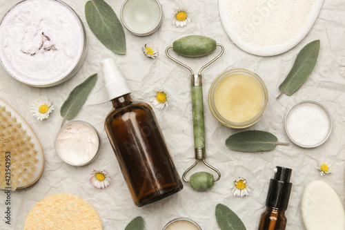 Natural organic skin care product. Home spa and self care product top view. Facial serums, essintials oils, creams, jade roller and soap bars with copy space.