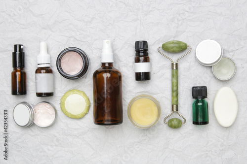 Natural organic skin care product. Home spa and self care product top view. Facial serums, essintials oils, creams, jade roller and soap bars with copy space.