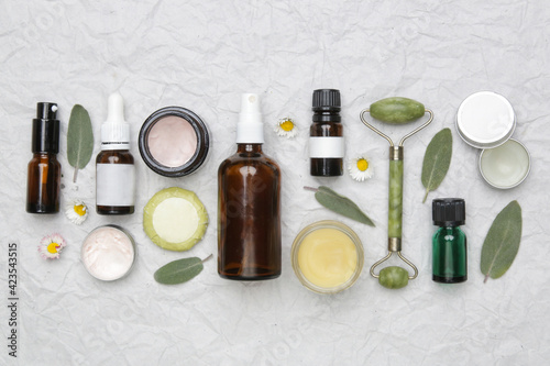 Natural organic skin care product. Home spa and self care product top view. Facial serums, essintials oils, creams, jade roller and soap bars with copy space.