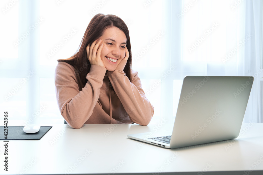 young woman talking by video chat on laptop young woman talking by video chat on laptop