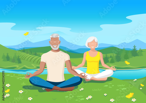 Active seniors practice yoga against the backdrop of a beautiful summer landscape. Active lifestyle in retirement.