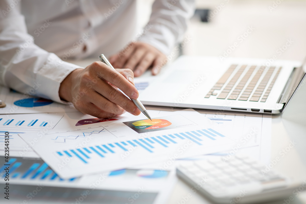 Business man hands hold documents with financial statistic stock photo,discussion and analysis data the charts and graphs. Finance concept Business man hands hold documents with financial statistic stock photo,discussion and analysis data the charts and graphs. Finance concept