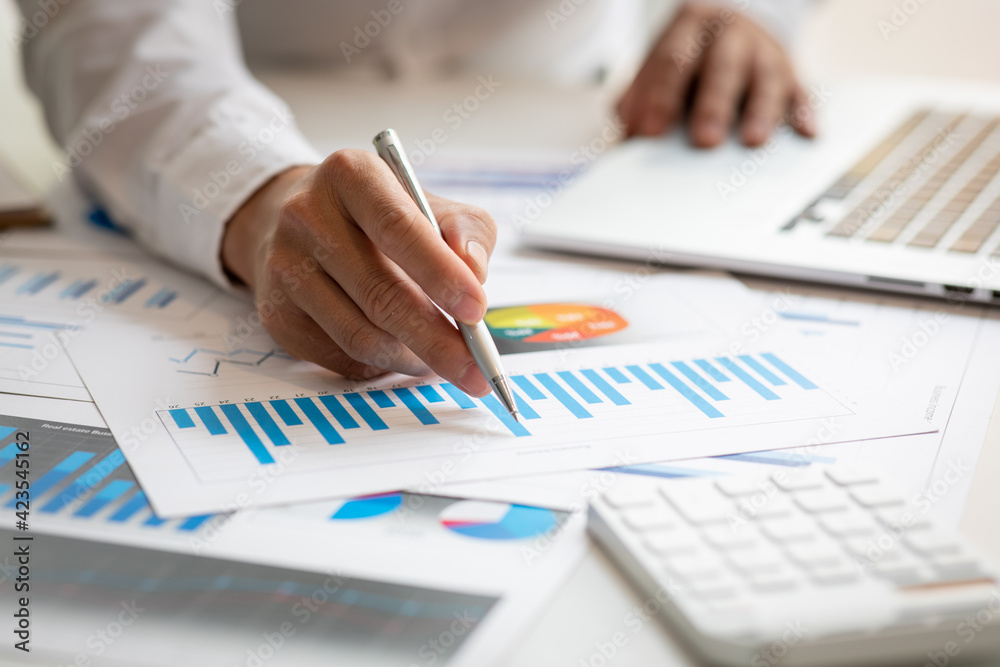Business man hands hold documents with financial statistic stock photo,discussion and analysis data the charts and graphs. Finance concept Business man hands hold documents with financial statistic stock photo,discussion and analysis data the charts and graphs. Finance concept