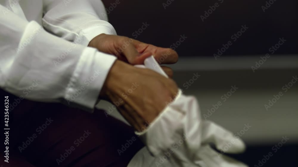 Close up of doctor or nurse putting on latex gloves for virus protection - isolated Close up of doctor or nurse putting on latex gloves for virus protection - isolated