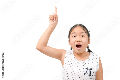 Cute girl shocked and pointing her finger upwards isolated on white background,