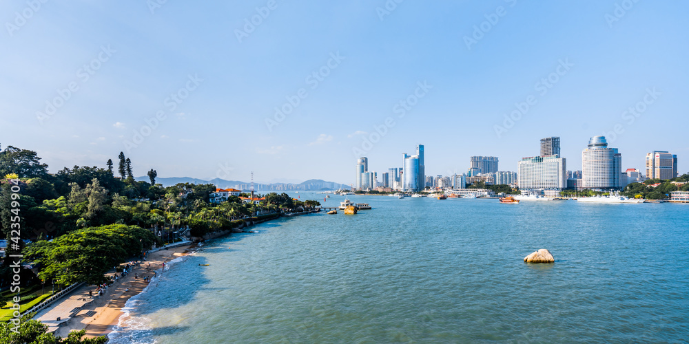 Sunny scenery of Gulangyu Island and city coastline in Xiamen, Fujian, China