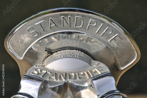 Beautiful closeup blurry view of silver standpipe head with inscription, Dublin, Ireland. Soft and selective focus