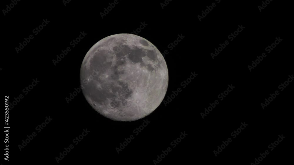 Full moon moves quickly in the dark sky. Beautiful big month Full moon moves quickly in the dark sky. Beautiful big month