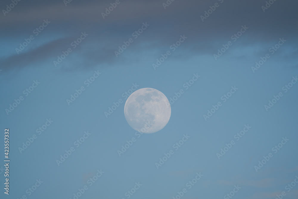 Big Moon with some clouds and blue sky at the afternoon Big Moon with some clouds and blue sky at the afternoon
