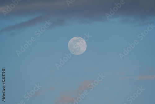 Big Moon with some clouds and blue sky at the afternoon