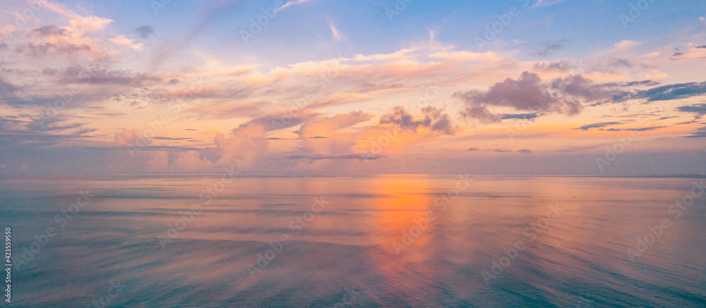Relaxing seascape with wide horizon of the sky and the sea. Sunset over the sea, tranquil nature view, aerial ocean panorama. Colorful clouds, sunrise sunset dream natural environment, Earth concept