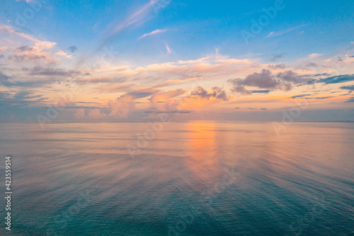 Relaxing seascape with wide horizon of the sky and the sea. Sunset over the sea  tranquil nature view  aerial ocean panorama. Colorful clouds  sunrise sunset dream natural environment  Earth concept