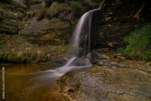 close up of the john knox waterfall in the lomond hills, fife, scotland.