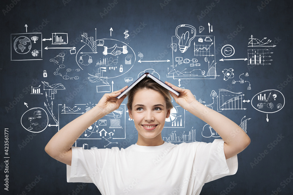 Woman wearing white t-shirt is holding book above her head Woman wearing white t-shirt is holding book above her head