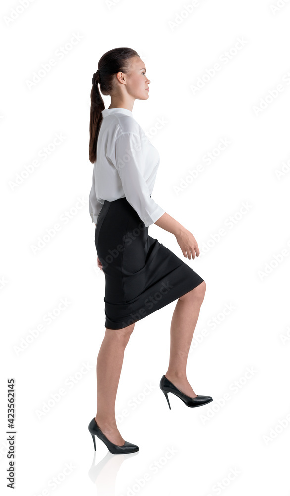 Young businesswoman is going up, isolated over white background Young businesswoman is going up, isolated over white background