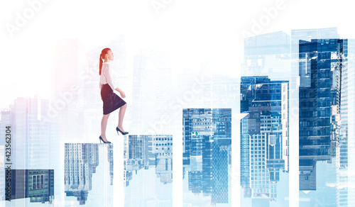 Fotografi Businesswoman climbing bar chart, double exposure of skyscrapers