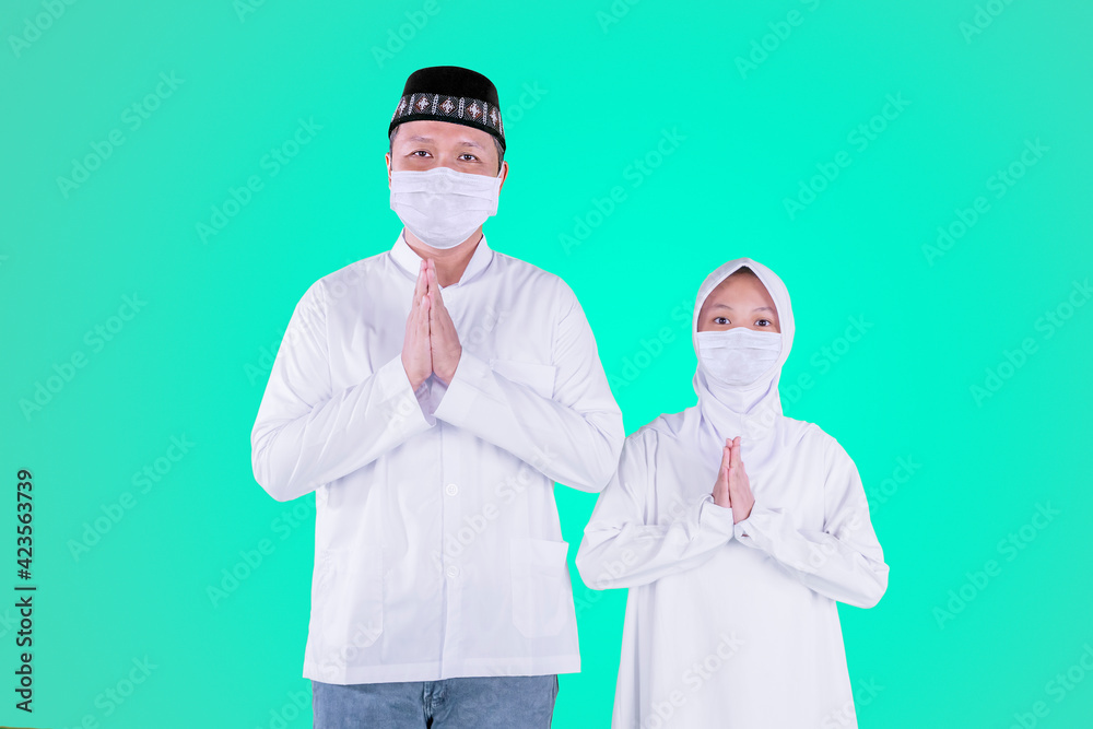 Father and child in mask congratulate Eid Mubarak Father and child in mask congratulate Eid Mubarak