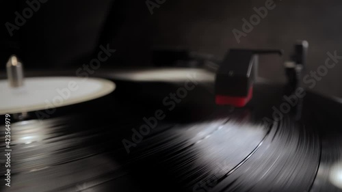 Playing a vinyl longplay on a record player - studio photography photo