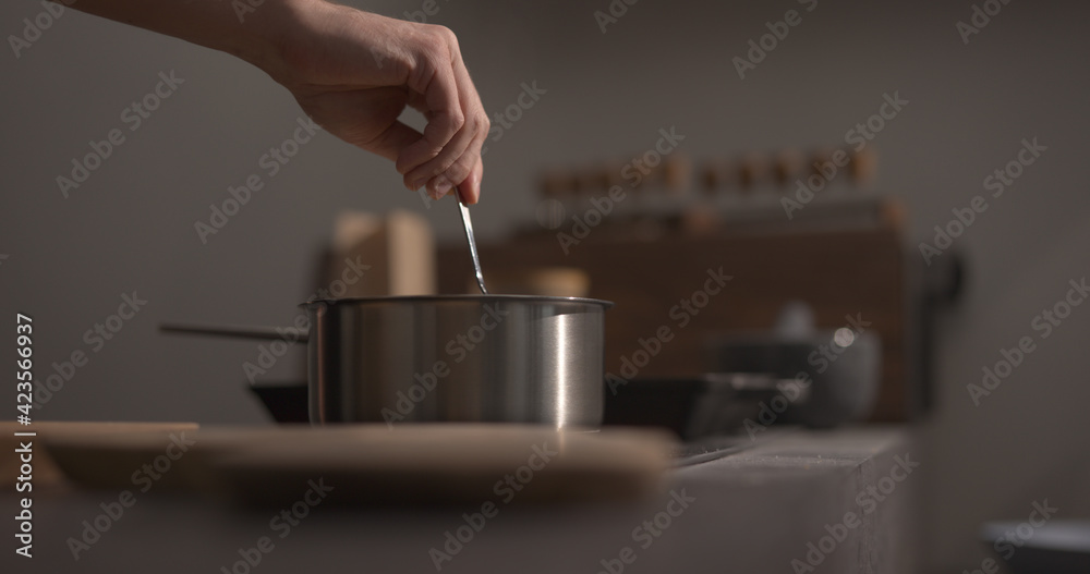 man hand stir fettuccine pasta in saucepan with boiling water closeup man hand stir fettuccine pasta in saucepan with boiling water closeup