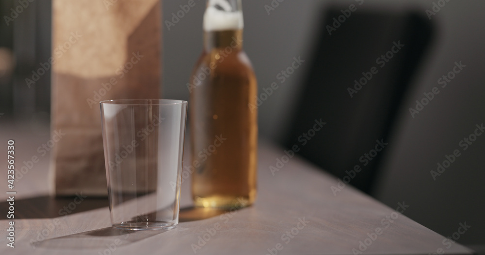 amber color fizzy drink in tumbler glass with bag of potato chips on background amber color fizzy drink in tumbler glass with bag of potato chips on background