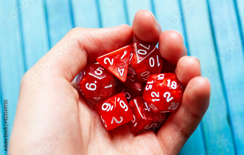Obraz na plátně Hand full of red polyhedral RPG board game dice, closeup