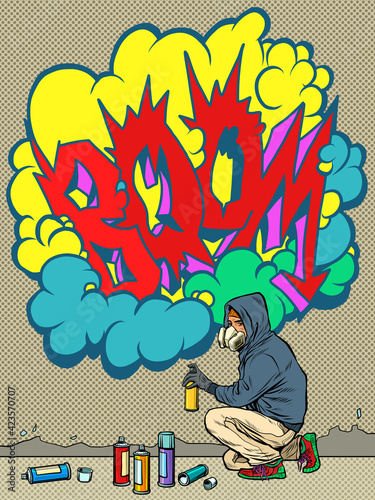 A teenage boy draws a graffiti image of the tag boom. street art