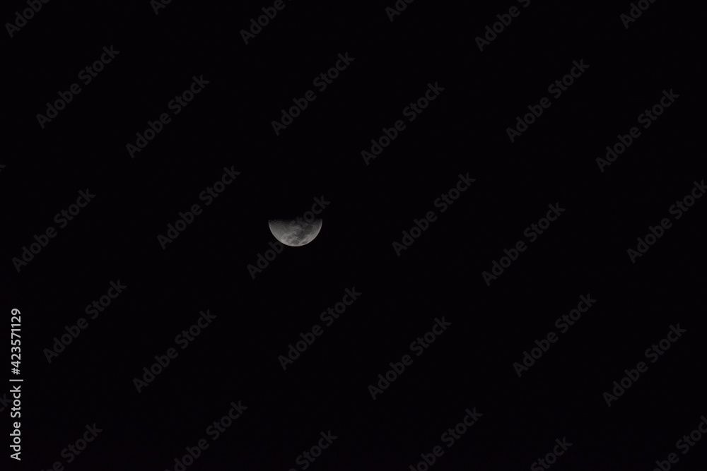 A beautiful almost half-moon on a calm and serene night A beautiful almost half-moon on a calm and serene night