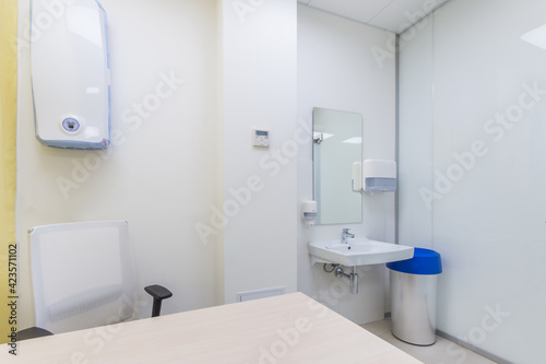 Doctor's office with wall mounted UV bactericidal air sterilizer and washbasin