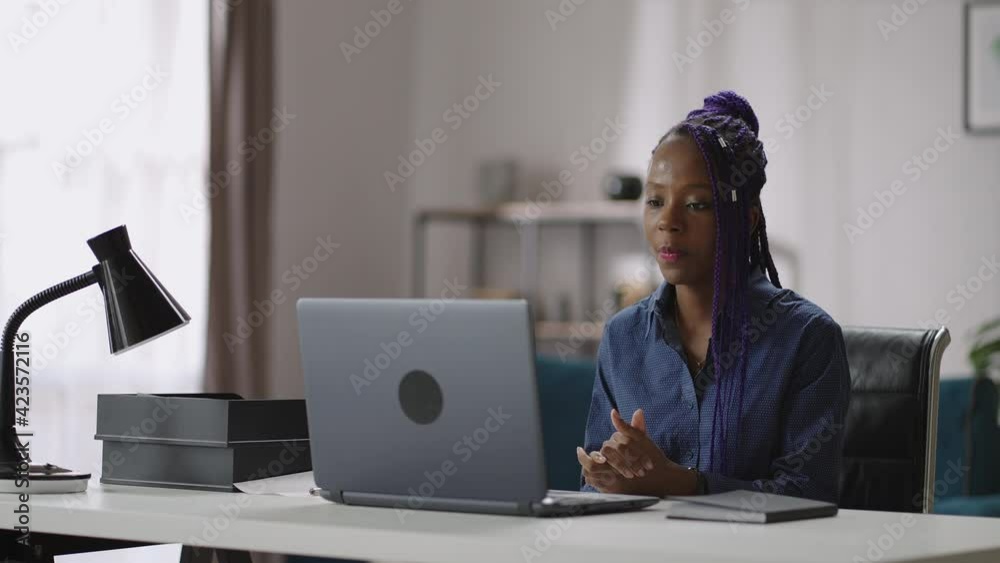 online communicating by video call in laptop, black woman is talking with colleagues during distant business meeting, working from home online communicating by video call in laptop, black woman is talking with colleagues during distant business meeting, working from home