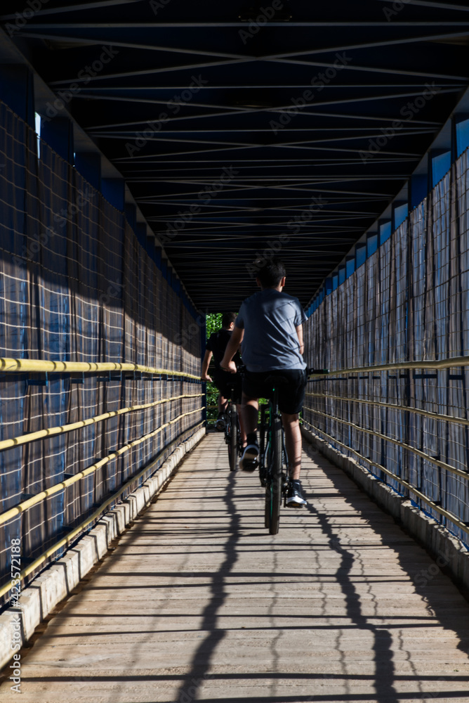 custom made wallpaper toronto digitalBoys crossing the footbridge on the BR 242 in Luis Eduardo Magalhães by bicycle.
