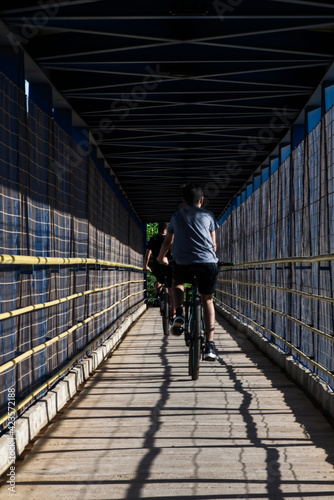 Wallpaper Mural Boys crossing the footbridge on the BR 242 in Luis Eduardo Magalhães by bicycle. Torontodigital.ca