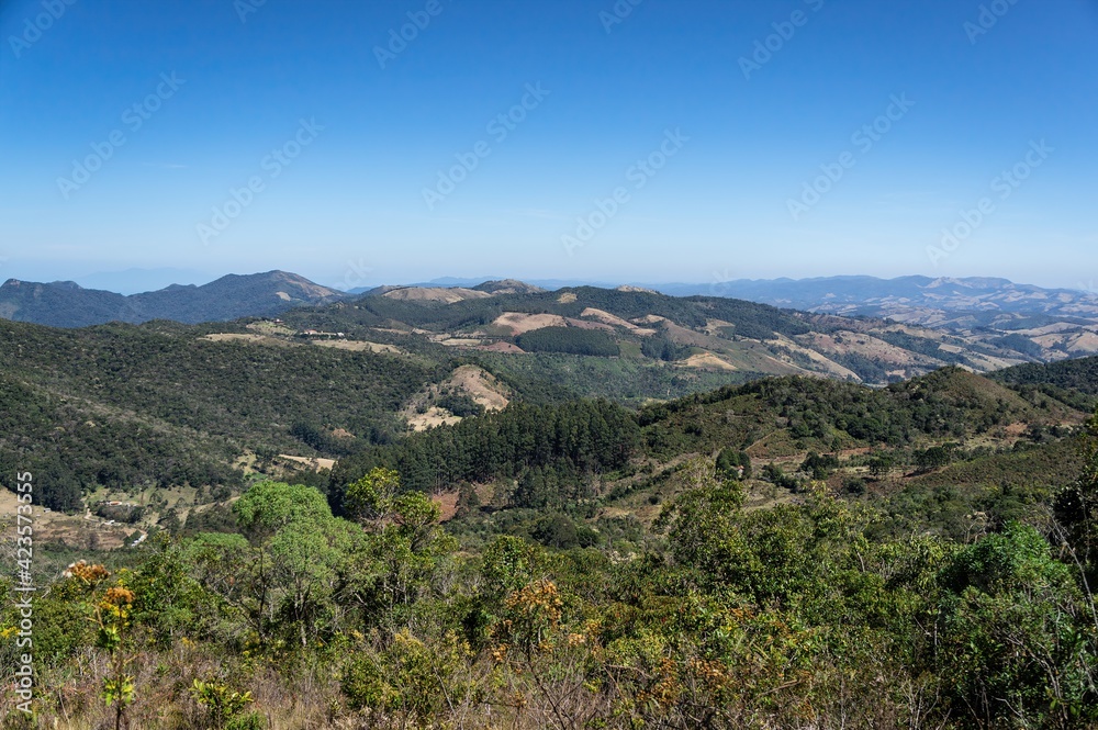 The surrounding mountainous green landscape under clear blue sky as saw from the Pedra da Macela viewing spots, inside Serra da Bocaina national park.
