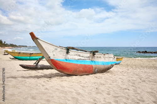 Small fishing boats on an empty beach, Sri Lanka.