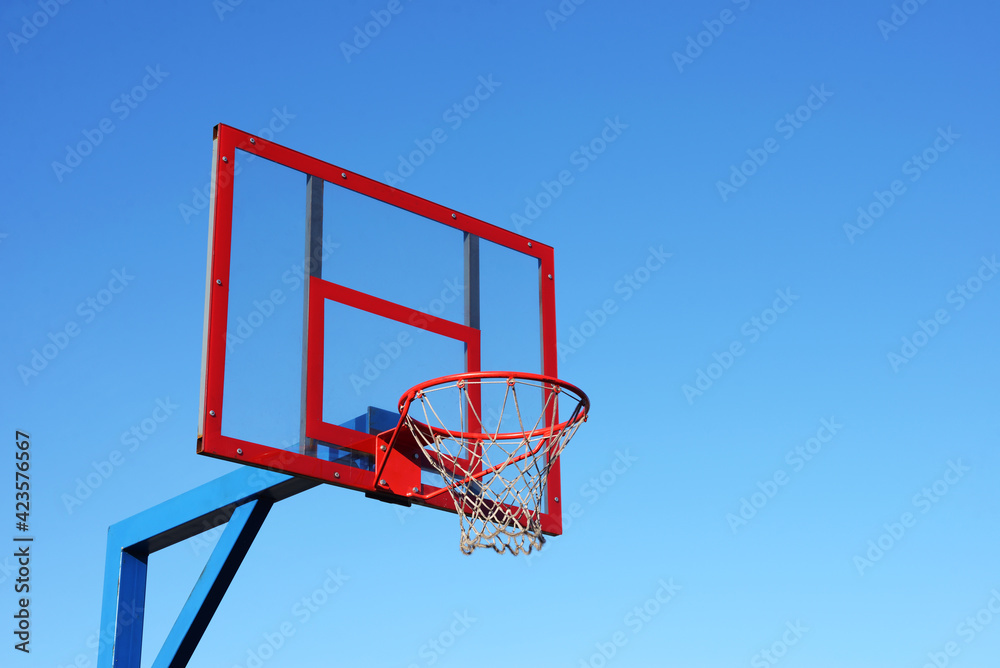 Basketball hoop on clear blue sky.