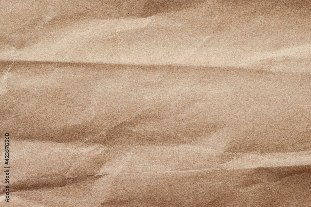 Obraz premium Crumpled paper with wrinkles, ecological or craft paper, surface texture close-up