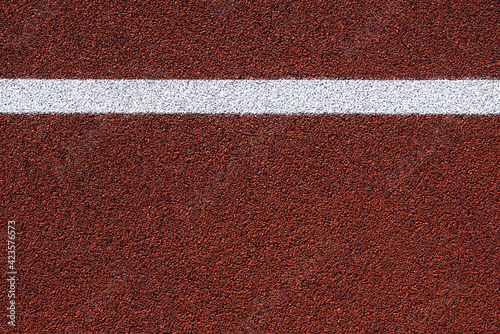 Red sports court or playground background with white line. © Kuzmick