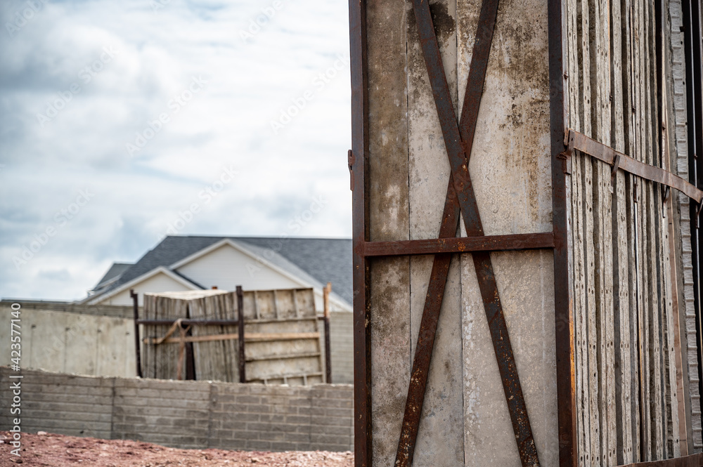 Obraz premium Stacked removable concrete forms for a basement at a residential home construction site