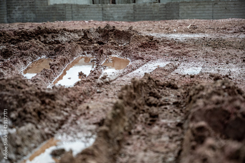 residential house construction under rain delay with mud and tracks